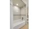 Bathroom features a tiled shower-tub combo and neutral walls at 6116 W Frost Dr, Littleton, CO 80128