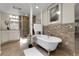 Elegant bathroom with a freestanding tub, stylish tile accents, and modern fixtures at 6116 W Frost Dr, Littleton, CO 80128