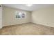 Bright and carpeted bedroom with a window and electrical outlets on the wall at 6116 W Frost Dr, Littleton, CO 80128