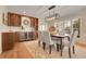 Sophisticated dining area with a modern light fixture, wine storage, and a view of the front yard at 6116 W Frost Dr, Littleton, CO 80128