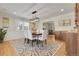 Elegant dining room with modern lighting, stylish rug, and a built-in bar area for entertaining guests at 6116 W Frost Dr, Littleton, CO 80128