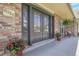 Inviting front entrance with stylish double doors, potted plants, and charming decor on the covered porch at 6116 W Frost Dr, Littleton, CO 80128