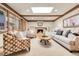 Living room features a fireplace, wood beams, a skylight, and comfortable seating at 6116 W Frost Dr, Littleton, CO 80128