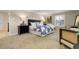 Spacious main bedroom with a plush carpet, a large bed, and ample natural light at 6116 W Frost Dr, Littleton, CO 80128
