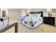 Comfortable main bedroom featuring a stylish bed, plush carpeting, and neutral decor at 6116 W Frost Dr, Littleton, CO 80128