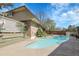 Inviting backyard pool with mature landscaping, privacy fence, and deck seating area at 6116 W Frost Dr, Littleton, CO 80128