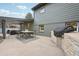 Outdoor patio features a dining table and grill with brickwork; the perfect space for entertaining at 2616 S Leyden St, Denver, CO 80222