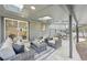 Backyard patio with ample seating area underneath a covered patio; table and grill can be seen to the side at 2616 S Leyden St, Denver, CO 80222