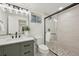 Modern bathroom featuring a glass shower, neutral tile, and modern fixtures at 2616 S Leyden St, Denver, CO 80222