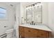 Bright bathroom featuring a wooden vanity with marble countertop and modern fixtures at 2616 S Leyden St, Denver, CO 80222