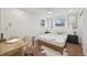 Cozy bedroom with natural light, desk, hardwood floors, and neutral decor at 2616 S Leyden St, Denver, CO 80222