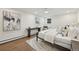 A bright bedroom with hardwood floors, a comfortable bed, and modern decor at 2616 S Leyden St, Denver, CO 80222