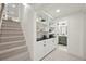 Hallway with built-in shelving and drawers and a view into the next bathroom at 2616 S Leyden St, Denver, CO 80222