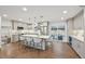 A bright, modern kitchen featuring gray cabinets, a quartz island with seating, and stainless steel appliances at 2616 S Leyden St, Denver, CO 80222