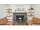 Cozy living room featuring a tiled fireplace, floating shelves, and modern furniture at 2616 S Leyden St, Denver, CO 80222