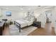 Bright main bedroom featuring modern furnishings, hardwood floors, and tasteful decor at 2616 S Leyden St, Denver, CO 80222