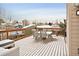 Elevated view of the back deck with a table and chairs, draped with decorative string lights at 9240 W Wagon Trail Dr, Littleton, CO 80123