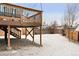 A wintery backyard showing the deck above and a fenced in yard at 9240 W Wagon Trail Dr, Littleton, CO 80123
