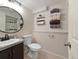 Modern bathroom with a granite vanity, updated fixtures, and a shower with glass doors at 9240 W Wagon Trail Dr, Littleton, CO 80123