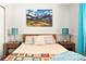 Cozy bedroom with a mountain view art piece above the bed, side tables, and warm lighting at 9240 W Wagon Trail Dr, Littleton, CO 80123