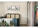 Bedroom with a black crib featuring a colorful quilt and a coordinated art display at 9240 W Wagon Trail Dr, Littleton, CO 80123