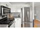 Updated kitchen features stainless steel appliances, granite countertops, and ample storage space at 9240 W Wagon Trail Dr, Littleton, CO 80123