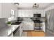 Bright kitchen featuring stainless steel appliances and light granite countertops at 9240 W Wagon Trail Dr, Littleton, CO 80123