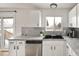 Kitchen with stainless steel dishwasher and a black composite sink at 9240 W Wagon Trail Dr, Littleton, CO 80123