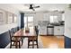 Modern kitchen with stainless steel appliances, granite countertops, and adjacent dining area at 9240 W Wagon Trail Dr, Littleton, CO 80123