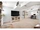 Spacious living area with a large TV, decorative cabinets, and ample room for a home office setup at 9240 W Wagon Trail Dr, Littleton, CO 80123