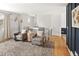Cozy living area with hardwood floors, stylish seating, and an open layout perfect for entertaining at 9240 W Wagon Trail Dr, Littleton, CO 80123