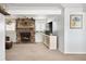 Bright living room with a stone fireplace, neutral walls, and contemporary decor at 9240 W Wagon Trail Dr, Littleton, CO 80123