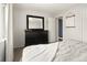 Bedroom featuring a large dresser and a glimpse into the attached closet at 9240 W Wagon Trail Dr, Littleton, CO 80123
