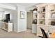Bright office area with built in storage, accent mirror, and warm colors at 9240 W Wagon Trail Dr, Littleton, CO 80123