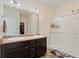 Bright bathroom featuring double sinks and a glass-enclosed shower at 2342 Shipman St, Brighton, CO 80603
