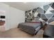 Cozy bedroom features a modern accent wall and comfortable decor at 2342 Shipman St, Brighton, CO 80603