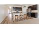 Modern kitchen with dark cabinets, stainless steel appliances, and breakfast bar at 2342 Shipman St, Brighton, CO 80603