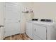 Laundry room with a door, washer, and dryer at 2342 Shipman St, Brighton, CO 80603