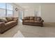 Bright and airy living room with large windows, neutral carpet, and comfortable seating at 2342 Shipman St, Brighton, CO 80603