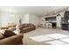 Open concept living room with a kitchen, neutral carpet and large sofa at 2342 Shipman St, Brighton, CO 80603