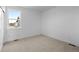 A sunlit bedroom with soft carpet and a large window offers a peaceful retreat at 2740 W 68Th Ave, Denver, CO 80221