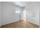 Minimalist bedroom features a window, wood floors, closet doors and plain white walls at 2740 W 68Th Ave, Denver, CO 80221
