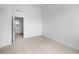 A light-filled bedroom with neutral carpet and white walls has an open doorway at 2740 W 68Th Ave, Denver, CO 80221