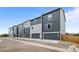 Modern townhomes with gray siding, garages, and well-maintained landscaping at 2740 W 68Th Ave, Denver, CO 80221