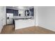 Contemporary kitchen with stainless steel appliances, white counters, and stylish navy cabinets at 2740 W 68Th Ave, Denver, CO 80221