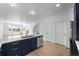 Open kitchen with stainless steel dishwasher and sink, flowing into the dining and living area at 2740 W 68Th Ave, Denver, CO 80221