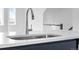 Close up of stainless steel kitchen faucet with a quartz countertop and sink at 2740 W 68Th Ave, Denver, CO 80221