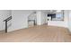 Spacious living room featuring wood floors flowing into an open kitchen and staircase at 2740 W 68Th Ave, Denver, CO 80221