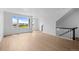 Bright living room with hardwood floors, large windows, and a staircase at 2740 W 68Th Ave, Denver, CO 80221
