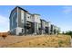 View of newly constructed townhomes with modern architecture and exterior balconies under a blue sky at 2740 W 68Th Ave, Denver, CO 80221